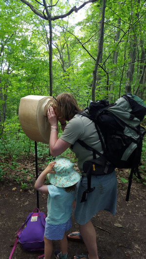 The coin operated binoculars house a tablet which plays an original animated short, created out of hundreds of watercolor panels. People interacting with the Landmarks sculpture