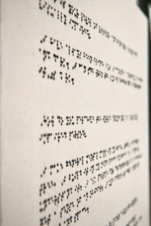 A detail of a canvas with Braille painted in paragraphs.