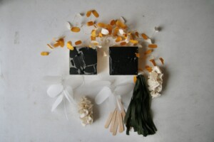 A full image of the mixed media sculptures surrounding the two square acrylic paintings.