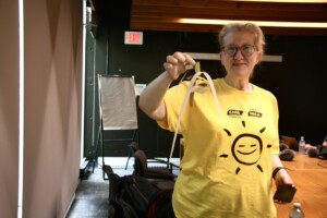 The CNIB Program Lead is holding up her completed mobile sculpture.