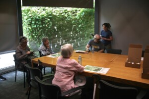 Dawn is teaching the participants how to use the audio recorder.