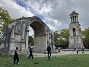 Ancient remains of a Roman tower and archway are still standing in a clearing.