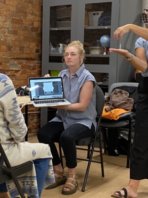 I am showing Marsha an image of my work on a laptop screen.